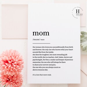 May include: A printable definition of the word "mom" with a white background and black text. The definition describes a mom as the woman who loves you unconditionally from birth and forever. The text is surrounded by pink flowers.