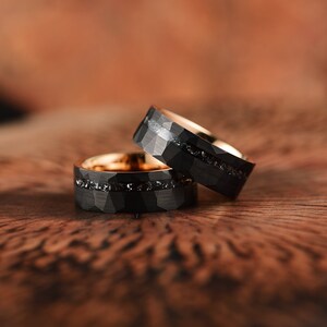 Mens matching Meteorite wedding band ring set crafted in meteorite hammered black tungsten and rose tungsten with a flat profile and a comfort fit interior. Rings By Pristine