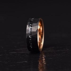 Meteorite mens wedding band crafted in meteorite hammered black tungsten and rose tungsten with a flat profile and a comfort fit interior. Rings By Pristine