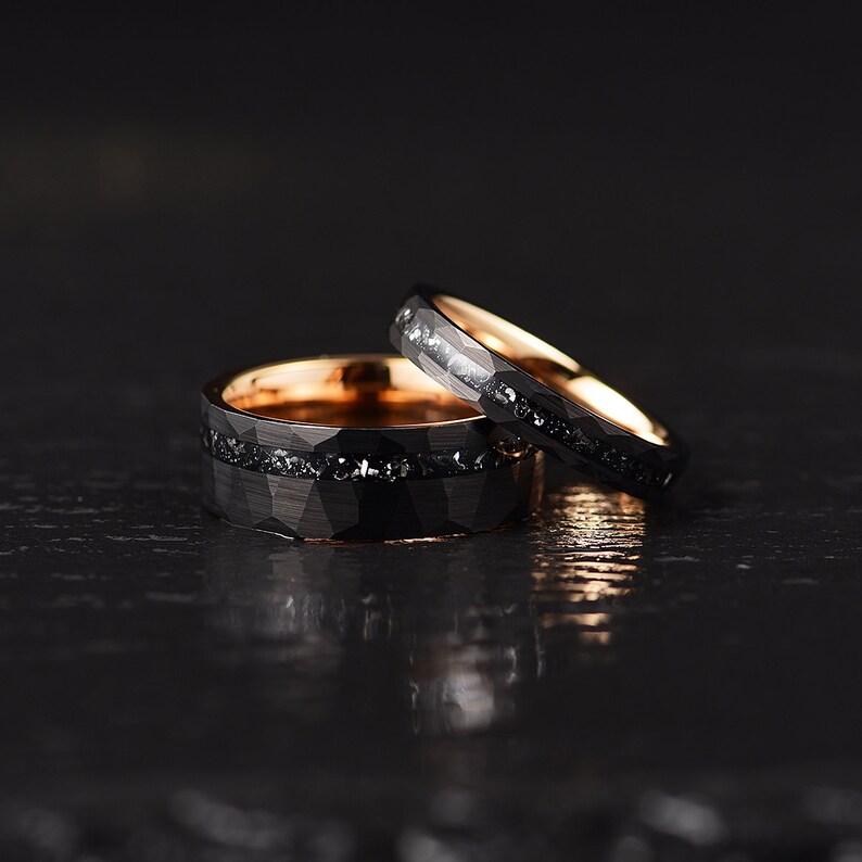 This stunning couples wedding band set in black hammered tungsten with a rose comfort fit interior and meteorite of set inlay and a flat profile is sure to be a show stopper. Rings By Pristine