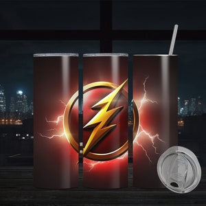 May include: Three stainless steel tumblers with a red and gold design featuring the Flash logo. The logo is a yellow lightning bolt inside a gold circle with red lightning bolts around it. The tumblers are on a wooden surface in front of a window with a city skyline at night.