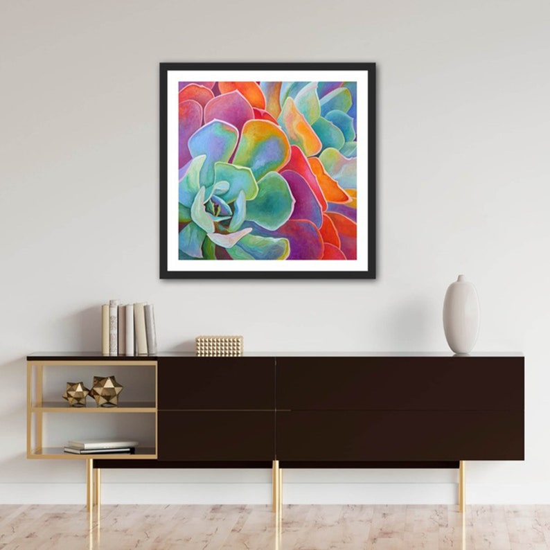 May include: Close-up of a vibrant succulent plant with overlapping layers of petals in shades of blue, green, orange, red, and purple.