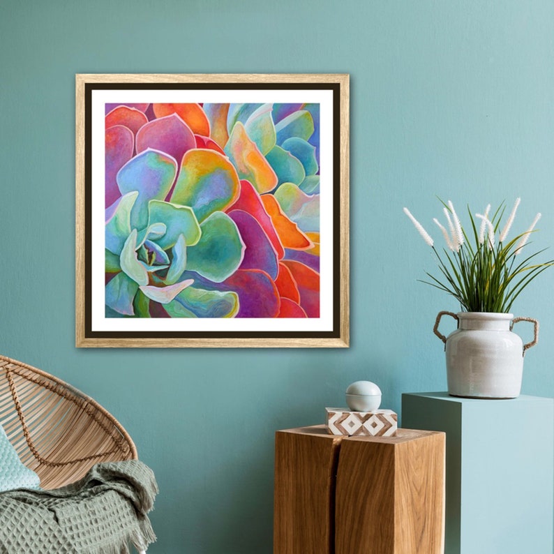 May include: Close-up of a colorful succulent plant with vibrant green, blue, purple, orange, and red hues. The succulent is framed in a brown wood frame.