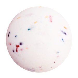 May include: A white bath bomb with colorful speckles of red, blue, yellow, and purple. The spherical bath bomb has a smooth surface and is designed for use in a bath.
