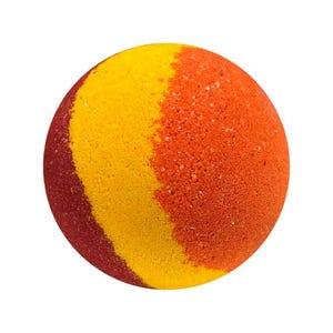 May include: A round bath bomb with a segmented design. The bath bomb is divided into three sections: red, yellow, and orange. The surface has a slightly textured appearance, and the colors are vibrant.