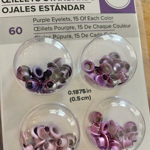 May include: 60 purple eyelets, 15 of each color, in four clear plastic containers. The eyelets are 0.1875 inches (0.5 cm) in diameter. We R memory keepers brand.