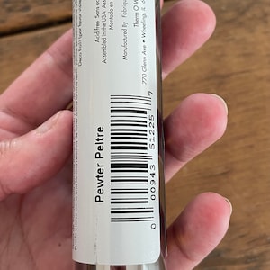 May include: A silver roll of Pewter Peltre foil in a clear plastic tube. The label includes the product name, a barcode, and the text "Acid-free Sans acide Sin &aacute;cido" and "Assembled in the USA Assembl&eacute;s aux &Eacute;tates-Unis Montado en los EE.UU".