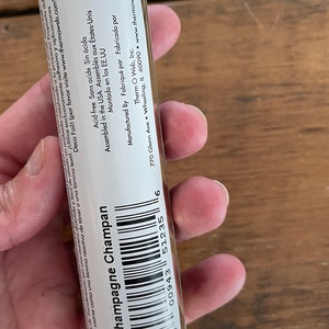 May include: A gold roll of adhesive foil labeled "Champagne Champan" with the product number 17422. The label also states that the product is acid-free, assembled in the USA, and manufactured by Therm O Web, Inc.