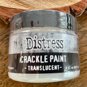 May include: A white jar of Distress Crackle Paint, labeled "Distress Crackle Paint - Translucent - 3 fl oz (88.7 ml)"