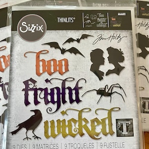May include: A Sizzix Thinlits die set in clear packaging featuring nine metal cutting dies. The package displays silhouettes of two bats, a spider, a crow, and two profiles, along with the words Boo, Fright, and Wicked in stylized fonts.