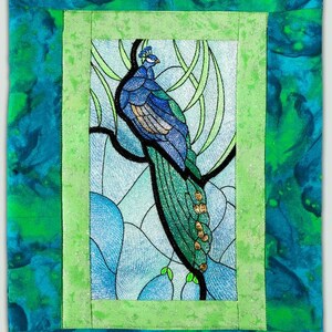 May include: A framed embroidery of a peacock with blue and green feathers, set against a blue and green background. The embroidery is in a stained glass style.