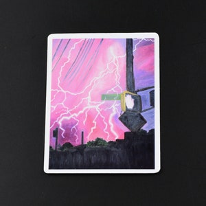 May include: A painting of a city street at night with lightning strikes in the sky. The streetlights are on and there are buildings in the background.