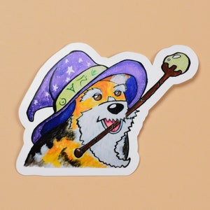 May include: A cartoon illustration of a dog wearing a purple and green wizard hat with stars and holding a brown and green wand. The dog has brown, orange, and white fur and is wearing a white beard.