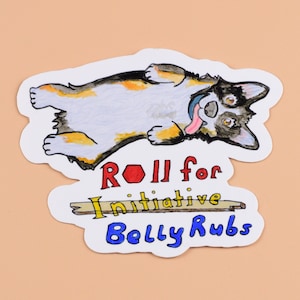 May include: A sticker featuring a cartoon illustration of a black and white dog with brown markings lying on its back with its tongue sticking out. The sticker has the text "ROLL for initiative Belly Rubs" in colorful letters.