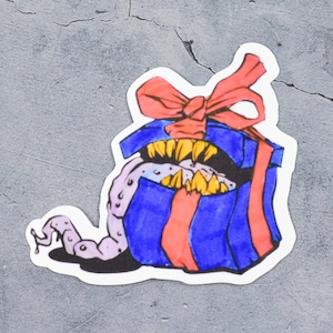 May include: A blue and red gift box with a red bow and a monster's mouth with sharp teeth and a pink tongue sticking out.