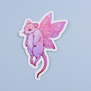 May include: A pink and purple mouse with wings, drawn in a watercolor style. The mouse has a long tail and is flying with its wings spread out.