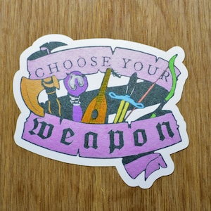 May include: A white sticker with a purple banner that says "Choose Your Weapon". The banner is decorated with a variety of weapons, including a lute, a sword, a bow and arrow, and an axe.