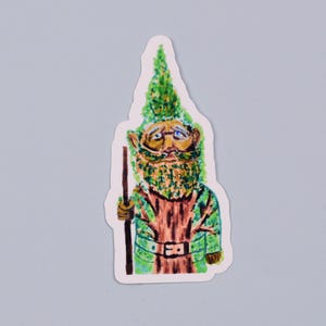 May include: A green and brown gnome sticker with a long beard and a pointed hat. The gnome is holding a stick in its right hand.