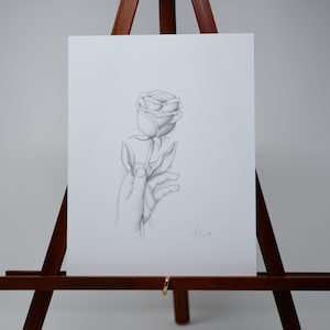 Hand holding a rose art print