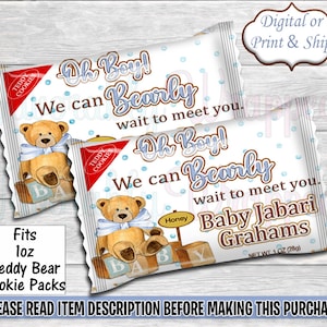 Puede incluir: Una bolsa de regalo para baby shower blanca y azul con un diseño de oso de peluche. La bolsa dice "Oh Boy! We can Bearly wait to meet you." y "Baby Jabari Grahams".