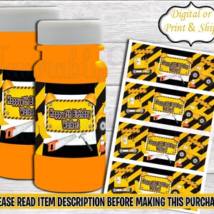 May include: Two orange bubble bottles with yellow and black construction themed labels. The labels say "Happy 7th Birthday Walker!" and feature a yellow construction vehicle.