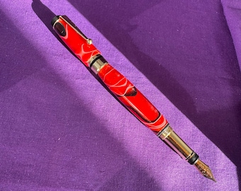 Red swirl resin fountain pen with gold fittings, handcrafted in Scotland