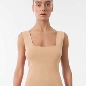 The beige sleeveless top blouse