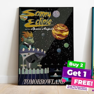 May include: Framed art prints featuring vintage-style travel posters. One poster has the text "Sommy Eclipse and the Space Angels" with a space-themed illustration. Another says "Tomorrowland". A third poster has a cartoon orange bird.