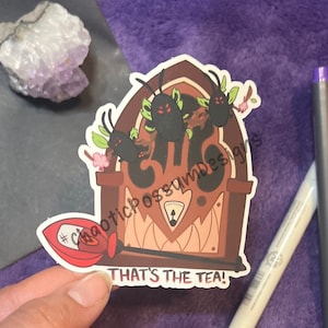 May include: A sticker featuring a brown radio design with black bug-like creatures and the text "THAT'S THE TEA!". The sticker has a red and white design with the hashtag symbol.