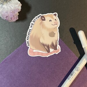May include: A sticker featuring a cartoon possum with the text "I am nervous, will scream". The possum is brown and white with a pink nose and tail. The sticker is on a purple background.