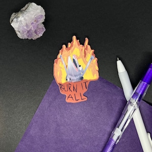 Könnte beinhalten: Ein Aufkleber mit einem Cartoon-Wolf in Flammen und dem Text "BURN IT ALL".
