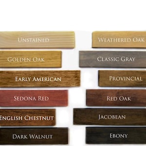 May include: Wood stain colour samples in various shades of brown, red, grey, and black. The samples are labelled with the names: Unstained, Golden Oak, Early American, Sedona Red, English Chestnut, Dark Walnut, Weathered Oak, Classic Grey, Provincial, Red Oak, Jacobean, and Ebony.