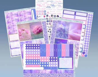 May include: A set of printable planner stickers with a purple and pink color scheme. The stickers feature floral designs, hearts, and text that says "am routine", "pes routine", "key day", "planning", "meals", "shopping", "organize", "Netflix", "Read", "Clean", "Do the Dishes", "In the Fridge", "Change", "No school", "Clean", "Carrots", "Day off", "Laundry", "Chiropractor", "WOW", "Monday", "Tuesday", "Wednesday", "Thursday", "Friday", "Saturday", and more.