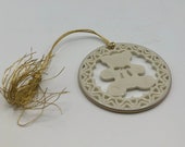 Lenox China Yuletide Teddy Bear Christmas Tree Ornament, ivory with gold rim and red hanging ribbon.