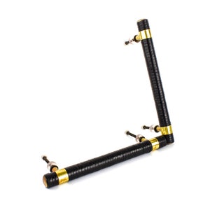 May include: Black and gold cabinet hardware with a textured finish. The handle is made of two pieces that connect at a 90-degree angle.