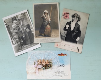 May include: Four vintage postcards featuring children. The first postcard shows two children in hats standing on a staircase. The second postcard shows a child holding a broom. The third postcard shows a child wearing a suit and hat. The fourth postcard shows three children in a basket with a fish.
