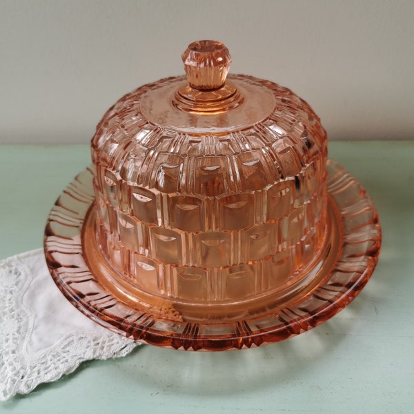 Pink molded glass bell and its Art Deco plate