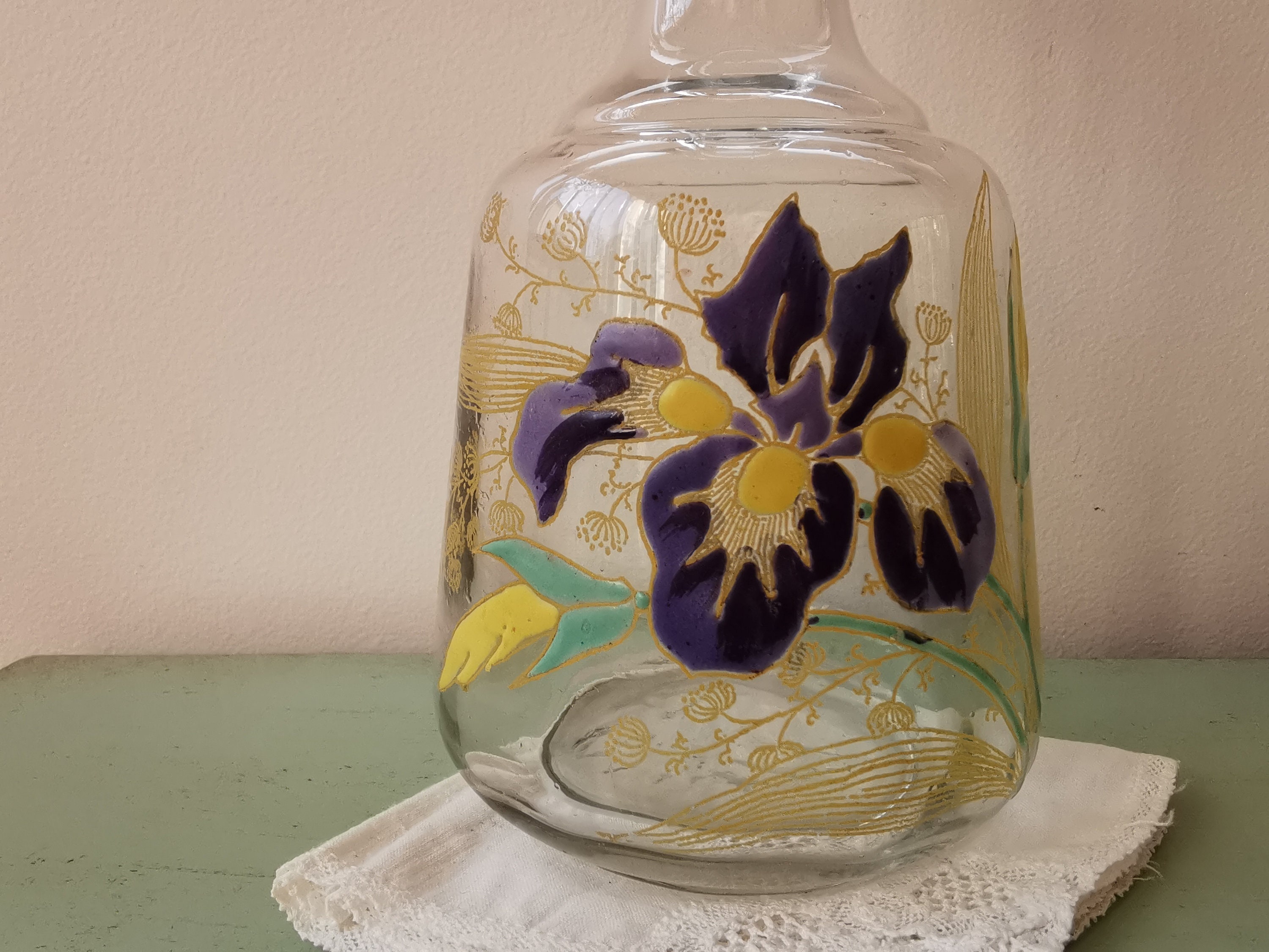 Art Nouveau carafe in enamelled glass decorated with flowers.
