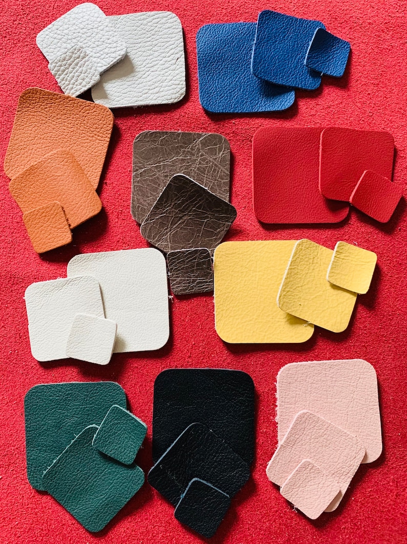 May include: Assortment of 10 different colored leather squares in various sizes. The squares are arranged in rows on a red background.