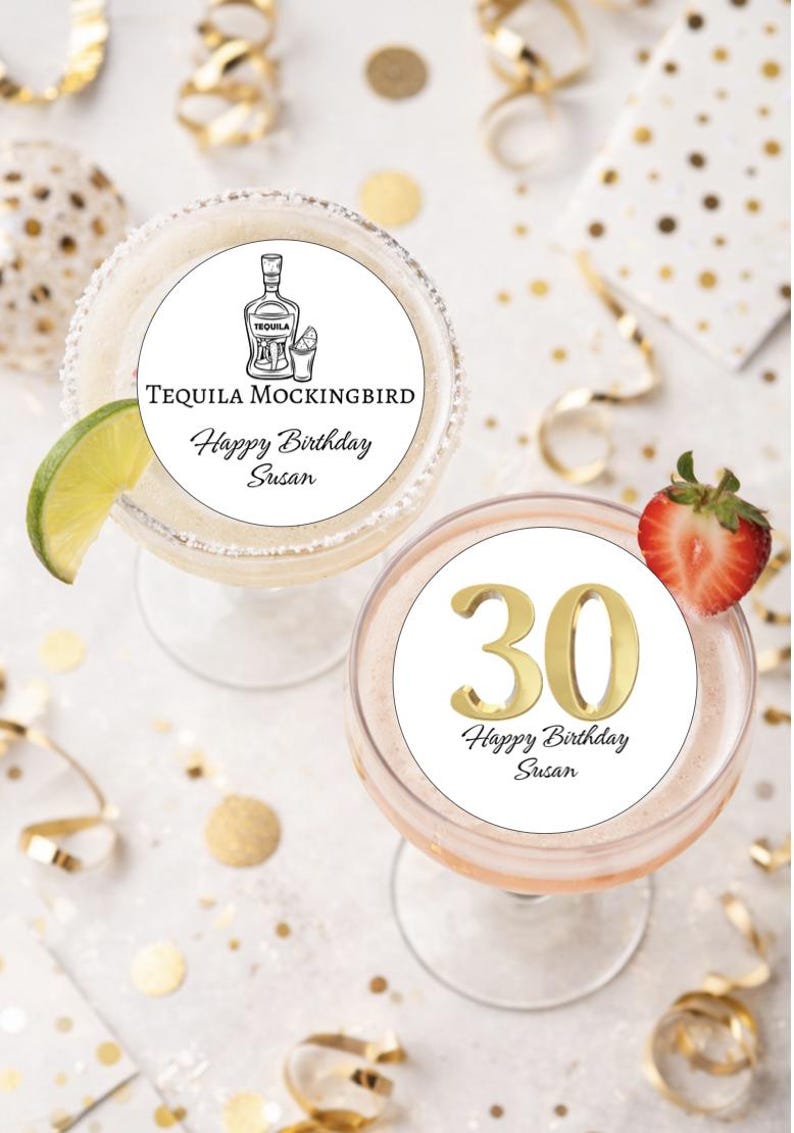 May include: Two cocktails, one a margarita with a lime wedge, the other a pink drink with a strawberry garnish. Both have white circles with text. One says "Tequila Mockingbird Happy Birthday Susan", the other has a gold "30" and "Happy Birthday Susan".
