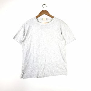 May include: A heather grey short-sleeved t-shirt hanging on a wooden hanger against a white background.