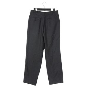 May include: Dark gray dress pants hanging on a black hanger. The pants have a classic, straight-leg design with a button and zipper closure. The back of the pants features two pockets and a tailored fit, suitable for formal or business attire.