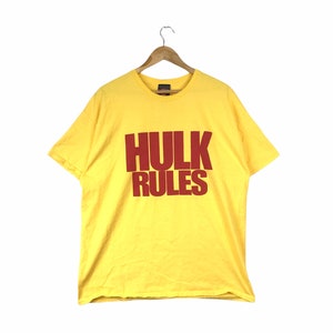 May include: Yellow short-sleeved t-shirt with the words "HULK RULES" printed in red.