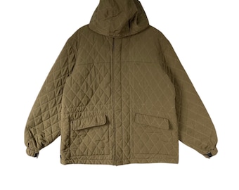 Könnte beinhalten: Olivgrüne Steppjacke mit Kapuze und zwei Vordertaschen. Die Jacke hat ein Rautenmuster im gesamten Stoff. Die Jacke hat einen Reißverschluss und ist für Oberbekleidung konzipiert.