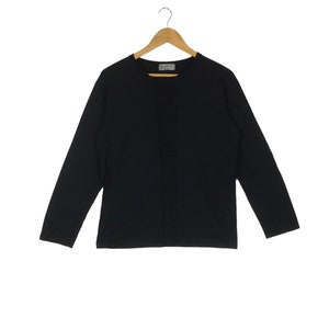 May include: A black long-sleeved shirt with a vertical seam down the front.