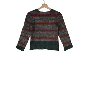 May include: A green, red, and white striped sweater with a long sleeve.