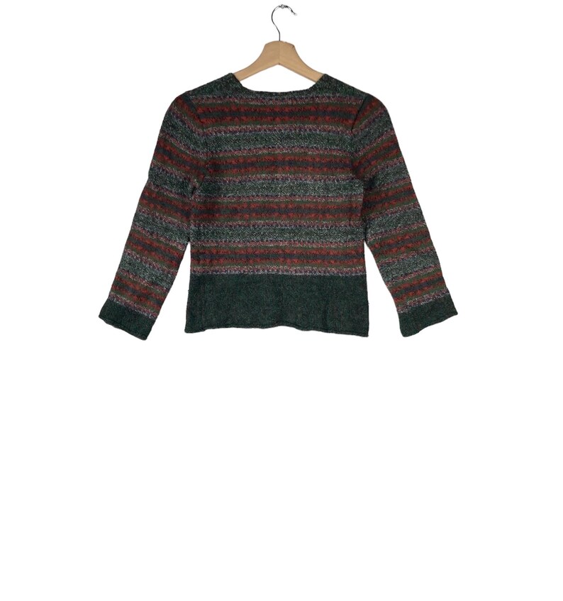 May include: A green, red, and white striped sweater with a long sleeve.