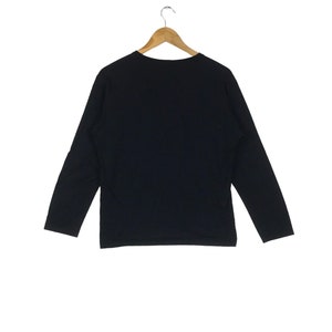 May include: A black long-sleeved shirt with a crew neck.