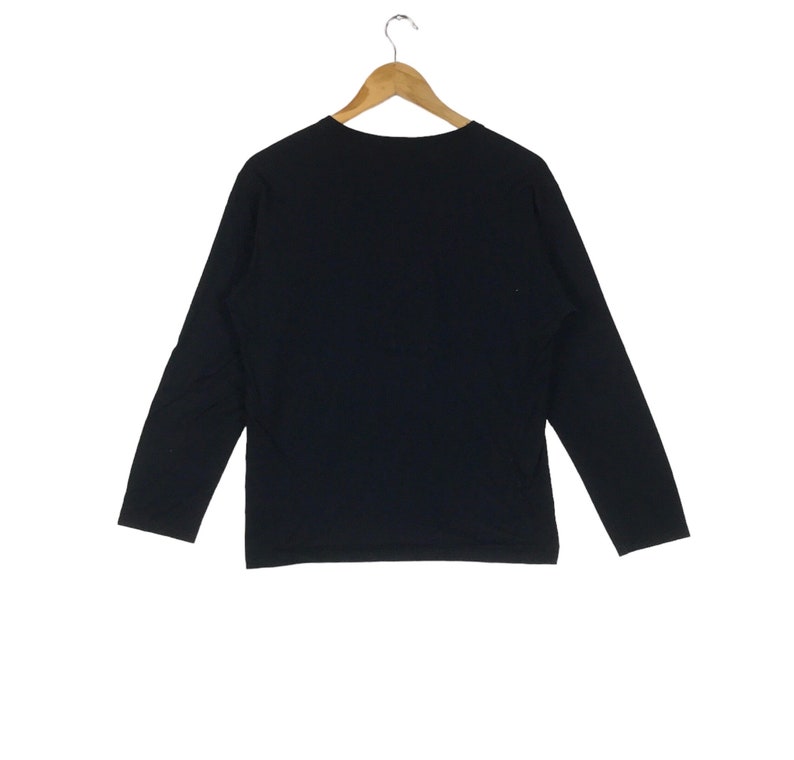 May include: A black long-sleeved shirt with a crew neck.