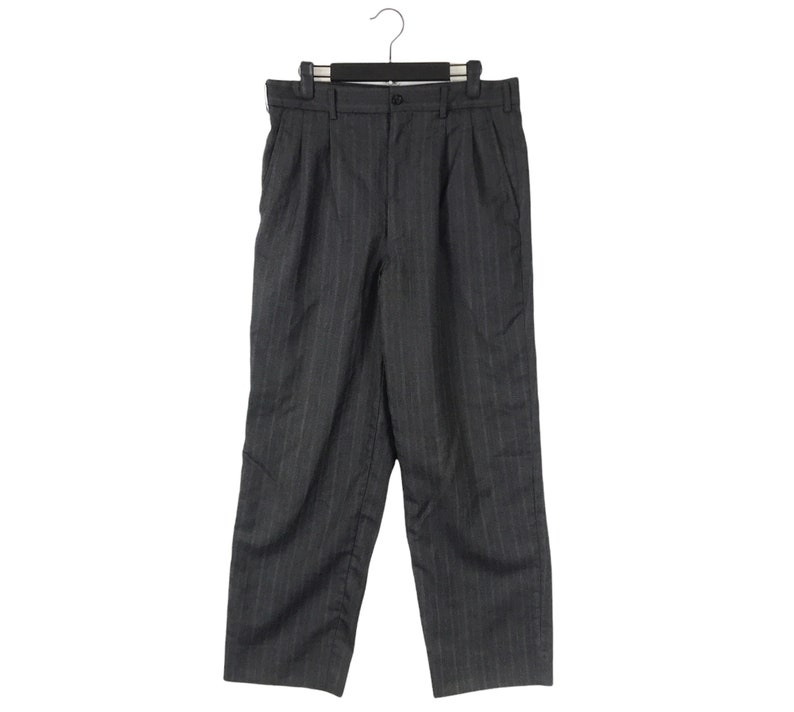 May include: Grey pinstripe trousers with a pleat at the front and a hanger.